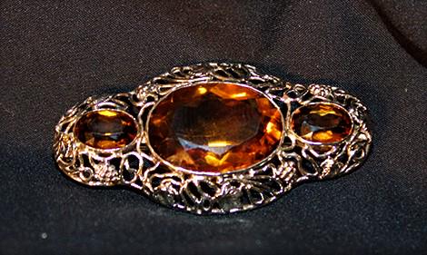 Fine 10k white gold broach with 3 large citrine stones: Fine 10k white gold broach with 3 large citrine stones. Very nice with a fancy reticulated setting, estate fresh.