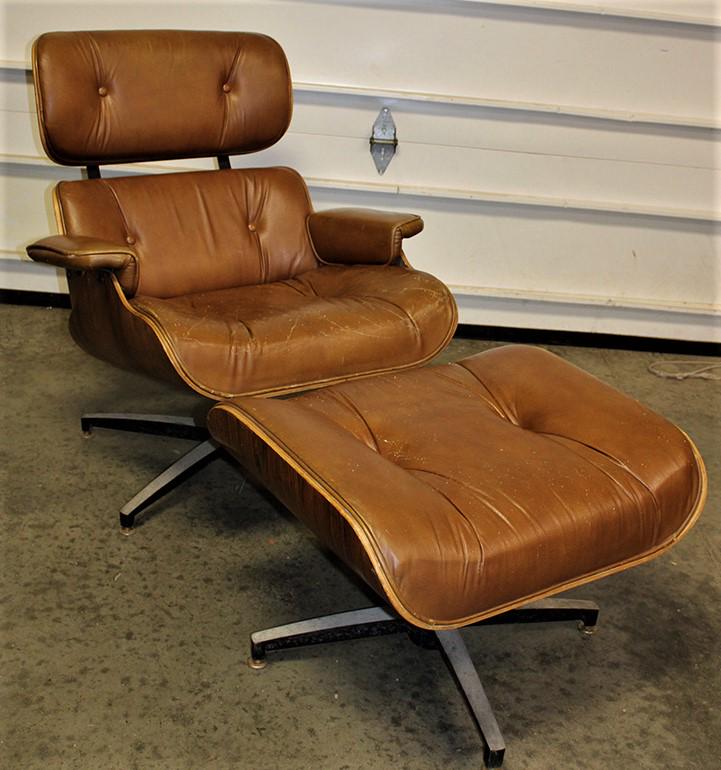 Herman Miller style leather lounge chair and ottoman in rosewood laminate: Herman Miller style leather lounge chair and ottoman in rosewood laminate. Has some small marks on the leather, no rips or holes. Chrome needs to be spruced up, marks where there was a label. 31" wide