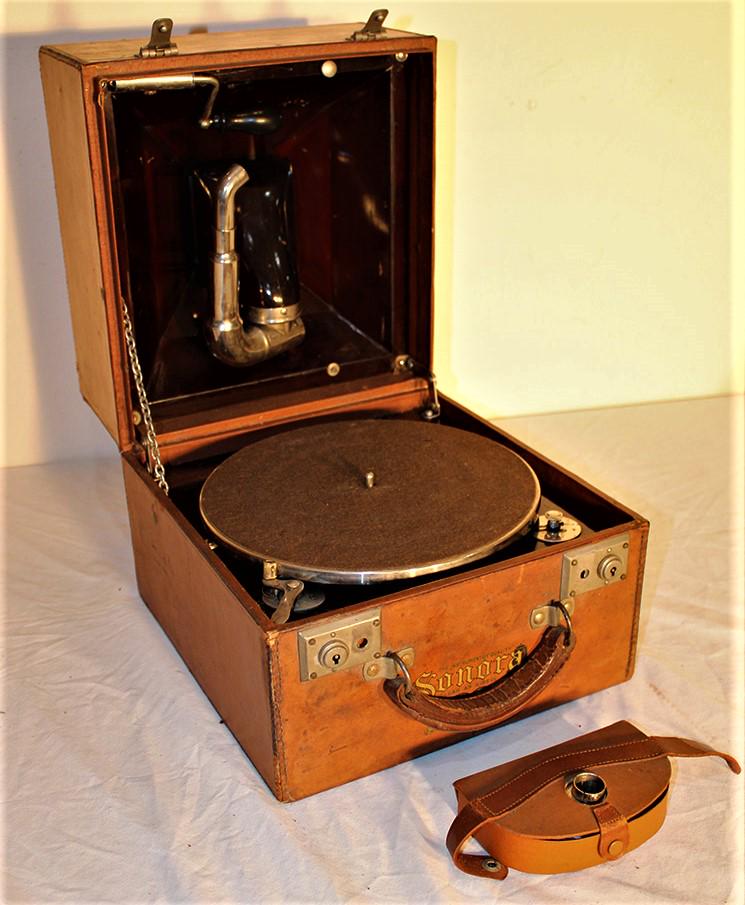 Very unusual traveling Sonora victrola in leather case: Very unusual traveling Sonora victrola in leather case in nice working condition. Leather has little wear (not much for its age). 12" wide, 11" tall, 12" deep.