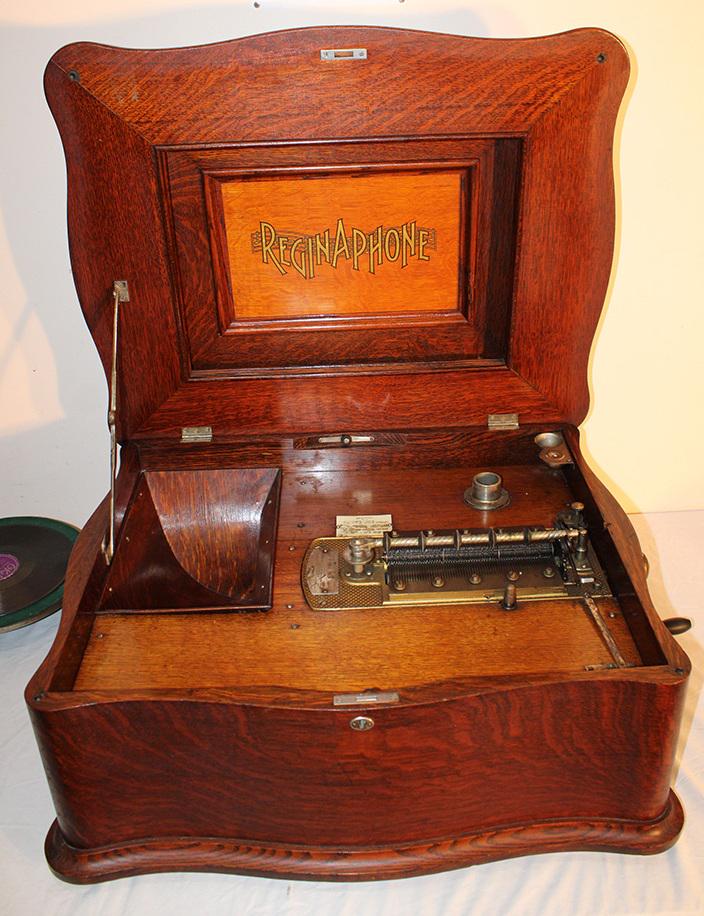 Extremely Rare Oak Reginaphone Music Box/Victrola: Extremely rare oak Reginaphone music box/victrola in excellent working condition, estate fresh. Nice original finish. Has 15 original 21" discs from 1 lifetime collection. 30" wide, 14" tall, 24" deep
