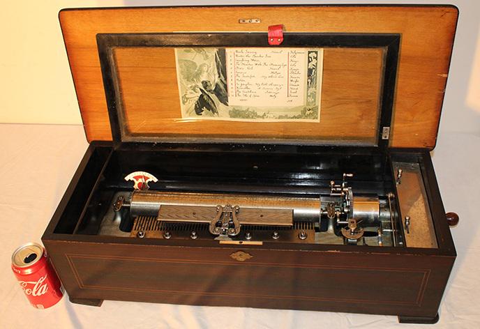 Pristine Inlaid 27" Cylinder Music Box With 24" Cylinder: Pristine inlaid 27" cylinder music box with 24" cylinder, plays 12 tunes. Estate fresh, works great. Teeth all good, US patent date 1894. 27" wide, 8" tall, 11" deep.