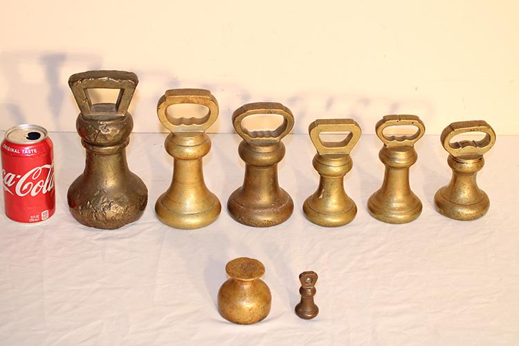 8 Early Brass Weights, 6 With Handles: 8 early brass weights, 6 with handles. Largest has some wear. 8" tall.