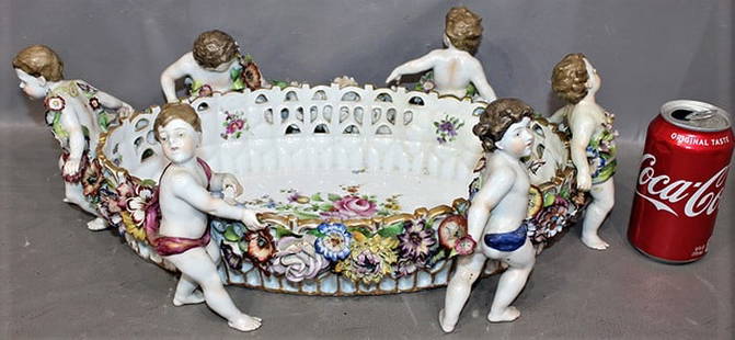 Nice Antique 19" Meissen Center Piece With 6 Puttis: Nice antique 19" Meissen center piece with 6 puttis. Hand painted, does have a line on one end (see photo). Great piece of porcelain, flowers look good (might be a couple of small chips). 19" wide,