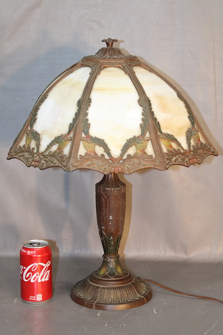 Signed Rainmaud slag glass panel lamp with Cornucopia design in original paint. Some chipping on the: Signed Rainmaud slag glass panel lamp with Cornucopia design in original paint. Some chipping on the paint, glass is good. 17" wide, 21" tall.