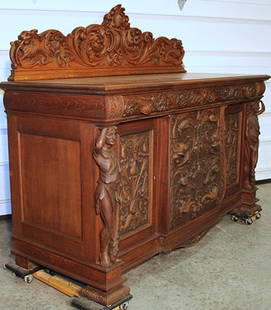 Massive Oak Signed Horner Sideboard With Standing Men With Clubs: Massive oak signed Horner sideboard with standing men with clubs. Bird, lion and flower carved pulls with massive crest. A remarkable piece of work. 70" wide, 57" tall, 27" deep.