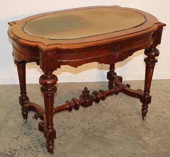 Walnut Victorian 1 Drawer Felt Top Library Table: Walnut Victorian 1 drawer felt top library table. Heavily carved legs and turned stretcher base in original finish. Missing 2 small buttons on the bottom (see photo). 40" wide, 29" tall, 26" deep.