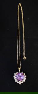 Beautiful 10K Gold Amethyst And Diamond Pendant And 14K Chain: Beautiful 10k gold amethyst and diamond pendant and 14k chain. Pendant is 1" top to bottom, chain is appr. 18" long.