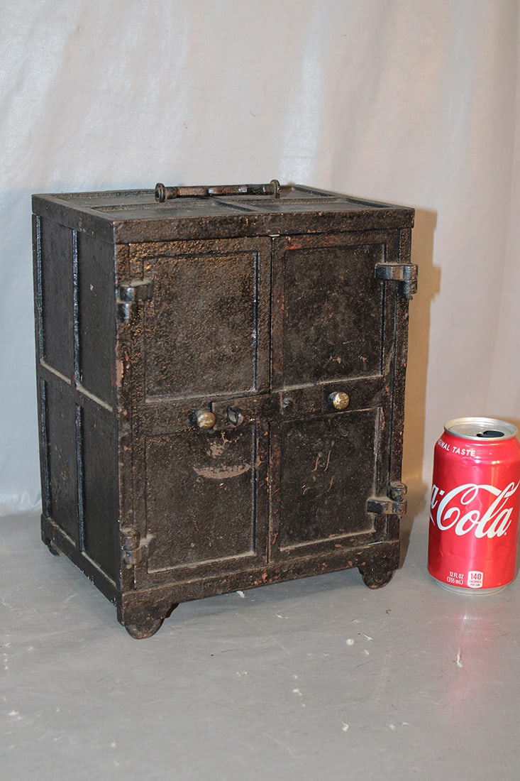 Miniature Victorian Cast Iron Safe With Handle Top And Double Doors: Miniature Victorian cast iron safe with handle top and double doors in an old black finish. Estate fresh. 9" wide, 12" tall, 7" deep.