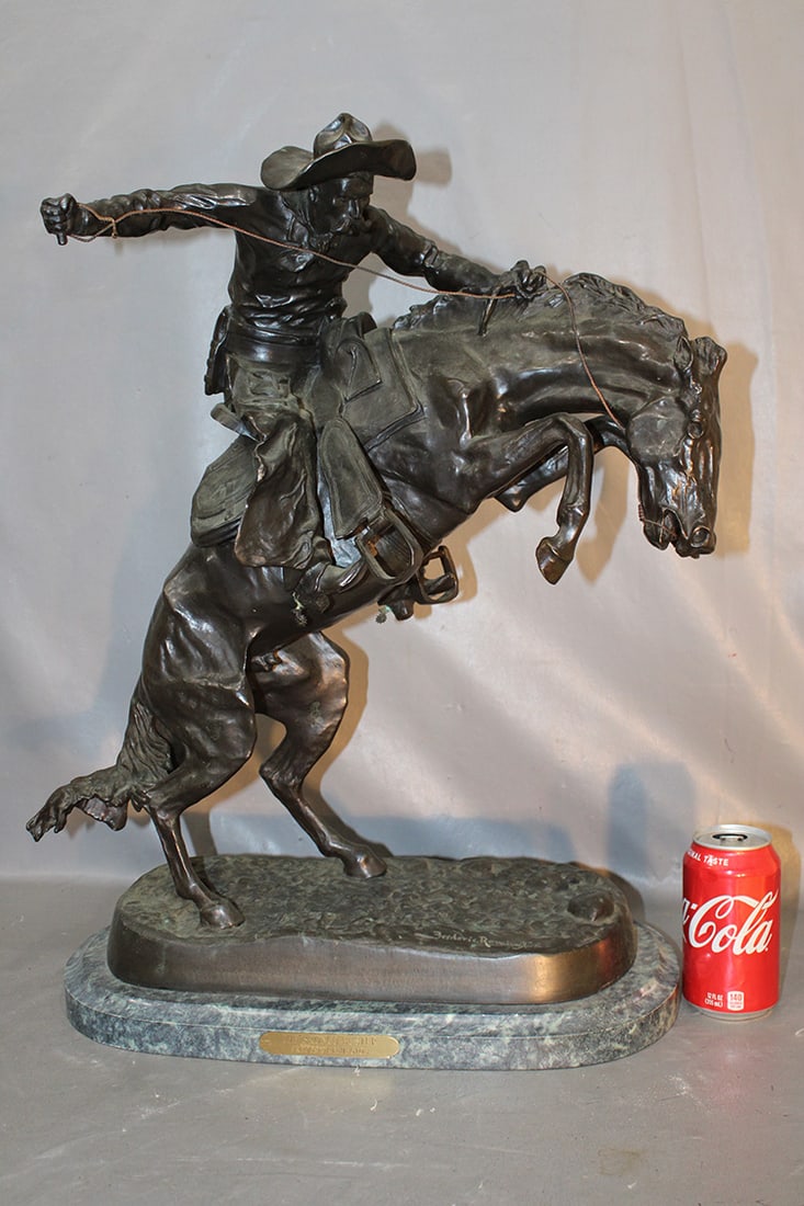 Large bronze by Frederic Remington titled Bronco Buster. Nice patina, green marble base, very heavy. (1 of 6)