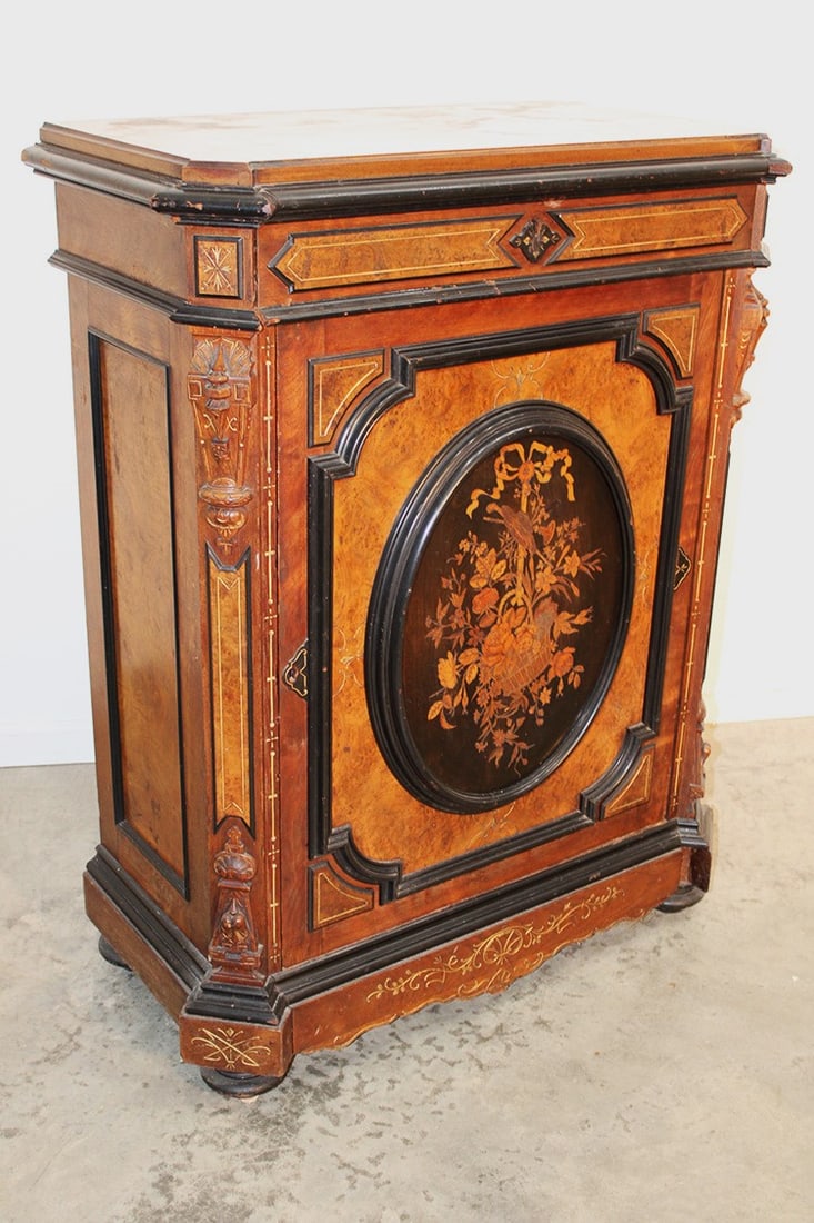 Super Victorian Renaissance marquetry inlaid credenza in original finish. Inlaid basket of flowers,: Super Victorian Renaissance marquetry inlaid credenza in original finish. Inlaid basket of flowers, burled side and top, gold incising with black trim. Missing a couple of small moldings. 36" wide, 46