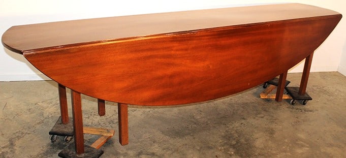 Hard to find 9' mahogany oval drop leaf country table. S wing legs, has normal wear. Estate fresh in (1 of 5)