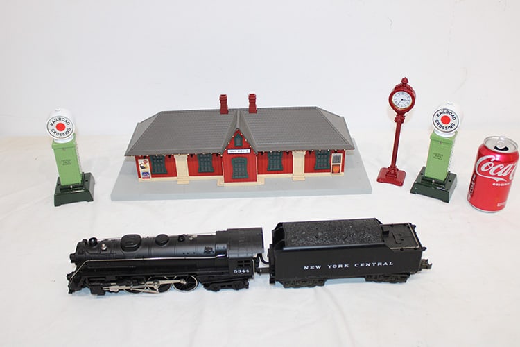 Group of MTH electric train accessories including train and tender #5344. Crossing signed, clocks, (1 of 5)