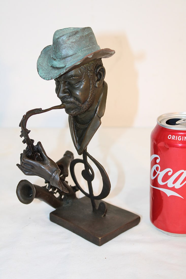 Signed Bronze Of Black Man Playing The Saxophone: Signed bronze of black man playing the saxophone. Nice patina, very detailed, signed Dwight. 9" tall.