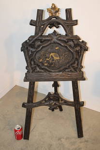 Fancy black forest magazine rack. Has an embroidered pelican on the front in original finish. 21": Fancy black forest magazine rack. Has an embroidered pelican on the front in original finish. 21" wide, 39" tall, 12" deep.