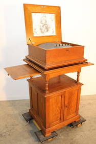 Super oak Regina music box and stand with (18) 15.5" discs in an original finish. Runs great. Total (1 of 12)