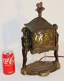 Art deco table lamp featuring 2 nudes with a light up center. Green glass with a butterfly finial. (1 of 8)