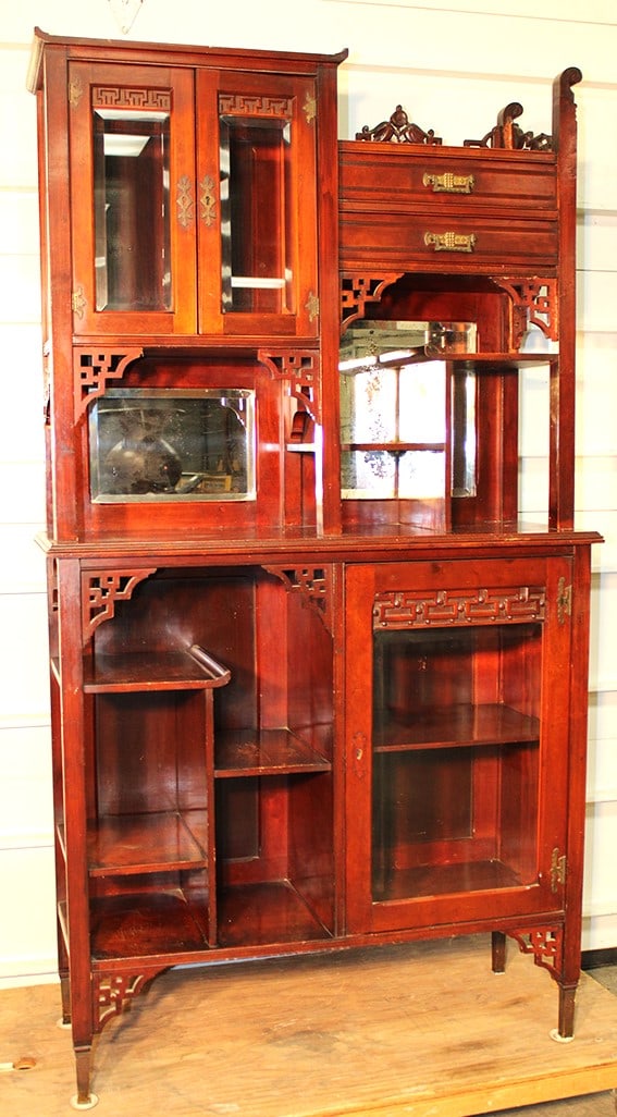 Victorian multi shelf etegere with 2 beveled curios. Original finish, fancy crest. Some flaking on: Victorian multi shelf etegere with 2 beveled curios. Original finish, fancy crest. Some flaking on the mirror, has a chip off the fretwork (see photo). 38" wide, 68" tall, 14" deep.