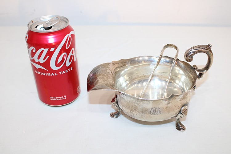 Signed Tiffany And Co. Sterling Footed Gravy Boat 9.42 Ozt: Signed Tiffany and Co. sterling footed gravy boat 9.42 ozt. Reproduction of the original George Jones London 1745. Plus a pair of Tiffany sterling tongs. Estate fresh in nice condition.