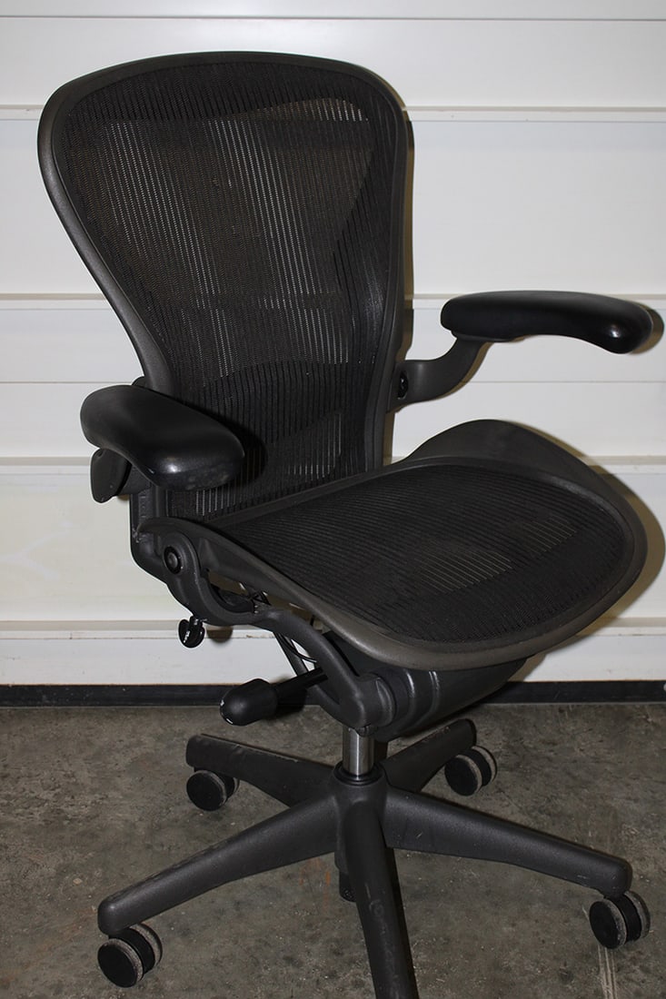 Signed Herman Miller Aeron Chair: Signed Herman Miller Aeron chair. Estate fresh in nice condition. A couple of small pulls in the back (see photo). 29" wide, 42" tall, 25" deep.