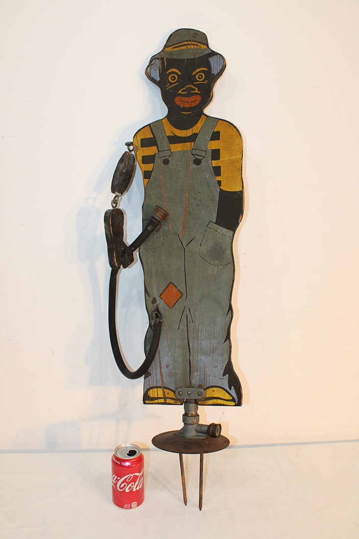 "Sprinklin Sambo" Garden Sprinkler: "Sprinklin Sambo" garden sprinkler. Estate fresh, all original paint. Wood and iron base with the original hose. Distributed by Dapco and Firestone Tire and Rubber Co. 39" tall (top to bottom).