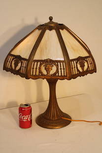18" 8 Panel Slag Glass Table Lamp: 18" 8 panel slag glass table lamp in nice condition. All panels are good with urn design and caramel slag. 18" wide, 21" tall.