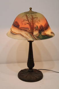 14" Antique Reversed Painted Table Lamp With A Snow Scene: 14" antique reversed painted table lamp with a snow scene. Very pretty colors and scene. Has a sliver on the shade (see photo). 14" wide, 22" tall.