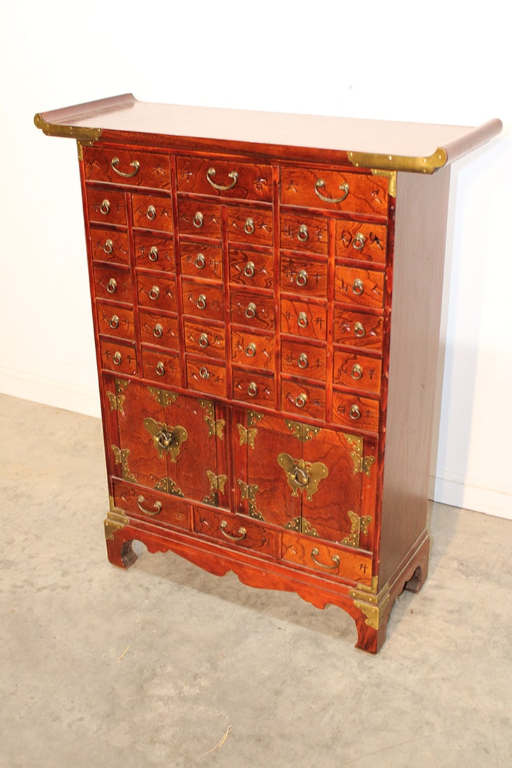 Nice Oriental 36 Drawer Apothecary Cabinet: nice oriental 36 drawer apothecary cabinet. Nice brass work design, cut out base. Second half of the 20th C., estate fresh in excellent condition. 30" wide, 37" tall, 11" deep.