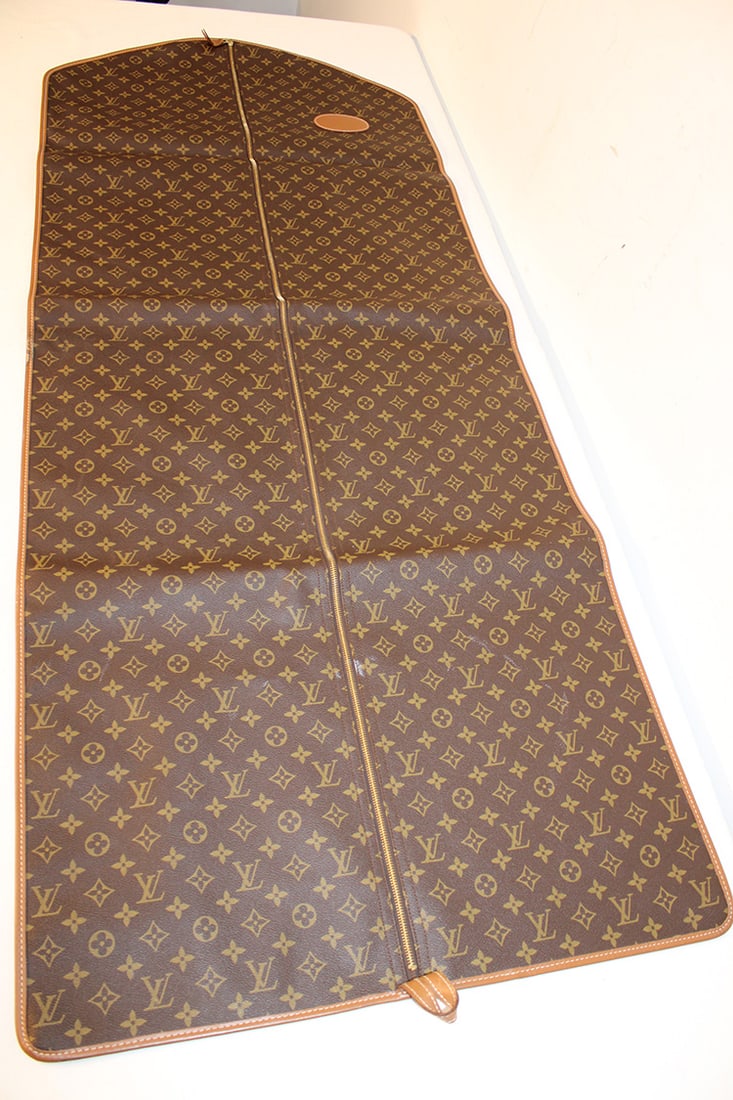 Louis Vuitton Garment Bad With Monogram LV: Louis Vuitton garment bad with monogram LV. Not sure if it's real or not, doesn’t look like it was ever used. The monogram is perfectly lined up, stitched are nice and straight. Nice condition. 24" 