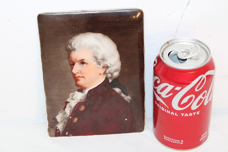 Artist Signed Antique Porcelain Plaque Of Mozart: Artist signed antique porcelain plaque of Mozart. Not framed, marked E 116. Signed M.L.B. on the front. 4.5" wide, 6.25" tall.