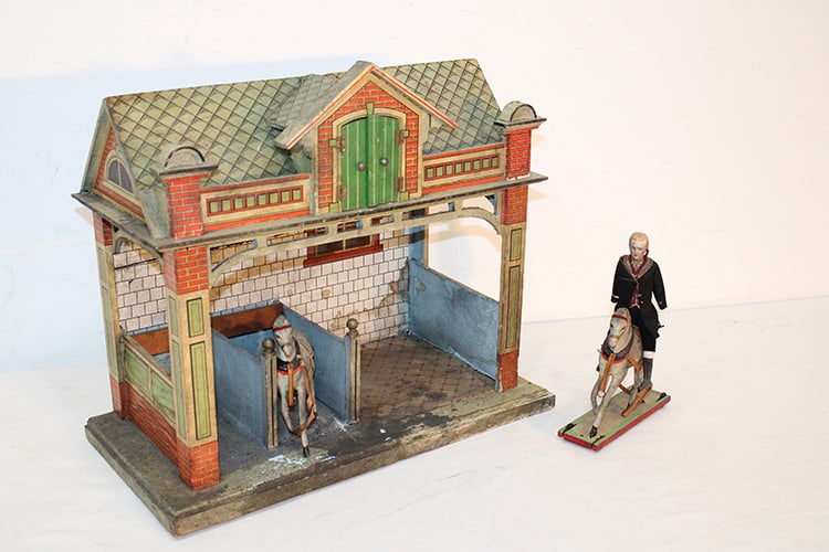 Early German wood stable covered by litho paper, possibly Gottschalk or Hacker. Has 2 early horses: Early German wood stable covered by litho paper, possibly Gottschalk or Hacker. Has 2 early horses (1) with a base and a bisque soldier in his original clothes. Has some wear but nice. Probably late