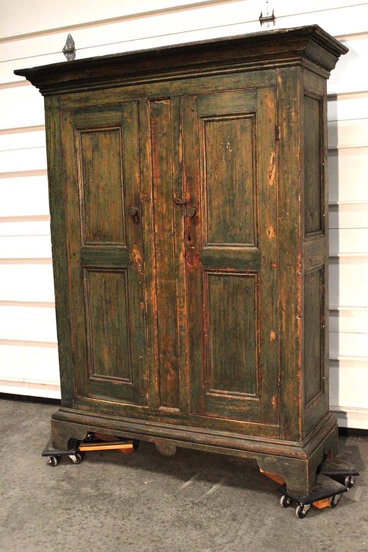 Early 18th or 19th C. 2 door cupboard in green. Nice tall cut out bracket base, paneled doors.: Early 18th or 19th C. 2 door cupboard in green. Nice tall cut out bracket base, paneled doors. Raised paneled inside, boards in the back are hand hewned. 1 replaced shelf. Stockbridge estate. 56"