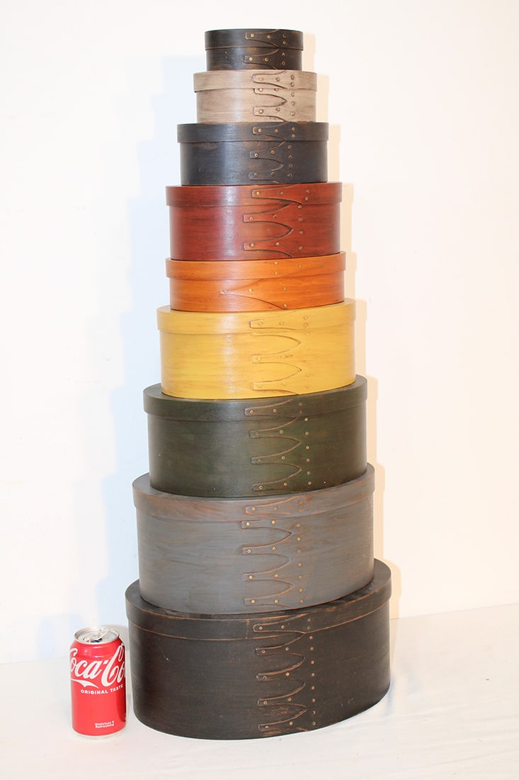 9 stacking Shaker style oval nesting pantry boxes in color. One says Shaker Workshop, looks to be (1 of 5)