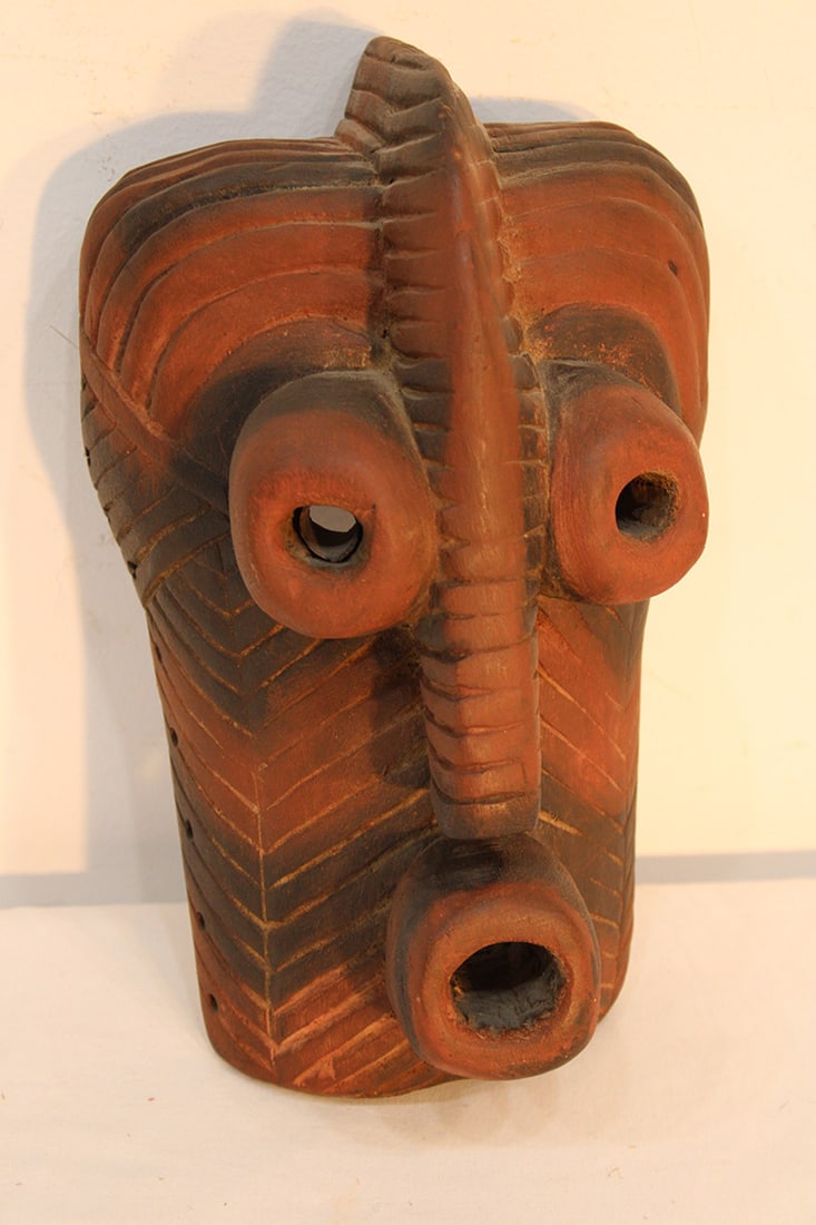 African Songyewooden mask. Red with black decorated carved wood bulging eyes and mouth. Private (1 of 4)