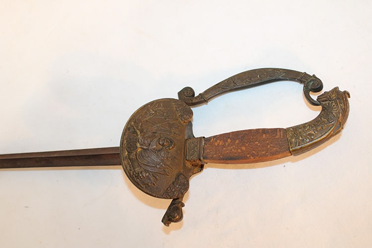 Antique sword with warriors, canons, dolphin (possibly a French officers sword). Real neat hilt,: Antique sword with warriors, canons, dolphin (possibly a French officers sword). Real neat hilt, looks to be a small chip on the tip. Pittsfield estate. No scabbard. Overall length is 36", blade is 31