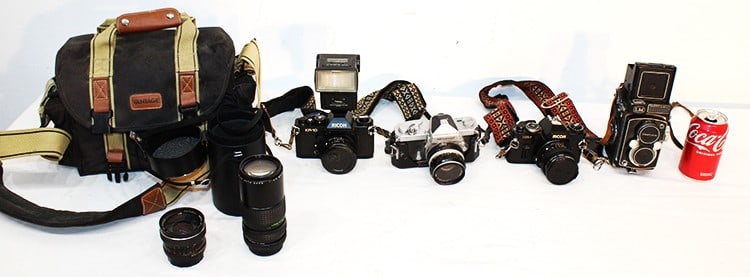 Group of estate cameras including Yashica, Ricoh, Nikkormat. Comes with vintage bag, extra lenses, (1 of 7)
