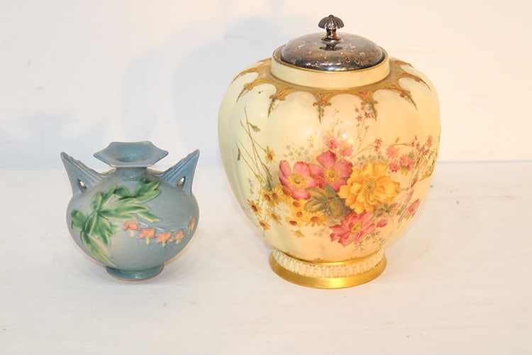 Royal Worcester blush ivory vase and Roseville bleeding heart vase. Larger has a replaced metal: Royal Worcester blush ivory vase and Roseville bleeding heart vase. Larger has a replaced metal cover, both are in good condition. Tallest is 8".