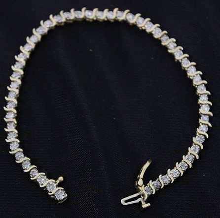 14K Gold And Diamond Tennis Bracelet With 50 Diamonds: 14k gold and diamond tennis bracelet with 50 diamonds. 4.6 dwt. Estate fresh, real nice. 7" long.