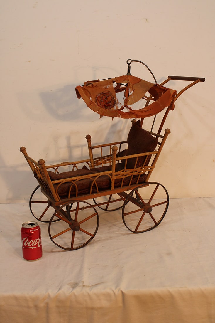 19Th C. Dolls Buggy With Wooden And Metal Wheels: 19th C. dolls buggy with wooden and metal wheels. Parasol (needs new material), buggy is in nice condition. Estate fresh.