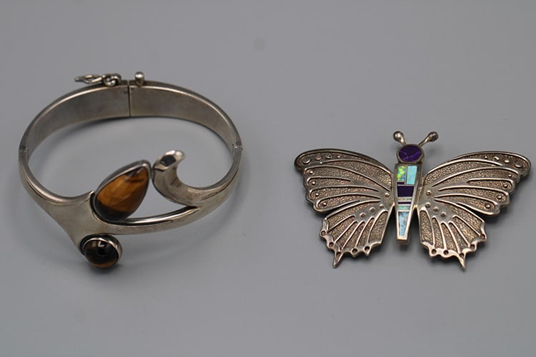 2 Nice Pieces of Sterling Silver Jewelry: 2 Nice Pieces of Sterling Silver Jewelry. Including enameled butterfly, sterling bracelet with a tiger eye quartz, both signed. Vermont estate.