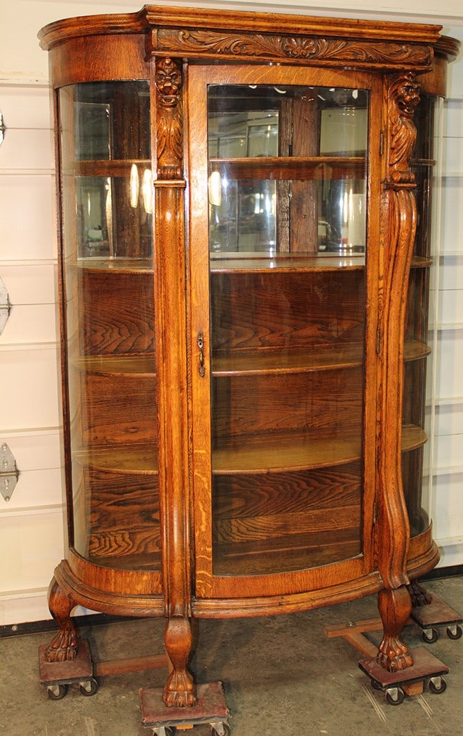 Antique Lion Head Oak Bow Front China Cabinet: Antique Lion Head Oak Bow Front China Cabinet. Large claw feet, mirrored back, carved top, all glass is good. All quartersawn oak, all wood and veneer are good with the original key. 46" wide, 69"