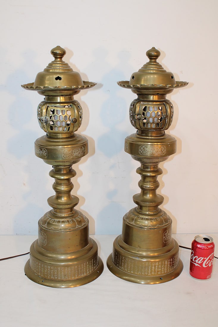 Pair of Antique brass Japanese Style Temple Lamps: Pair of Antique brass Japanese Style Temple Lamps. 26" tall with lights in them, writing all around the base, with doors on the top. Lee estate.