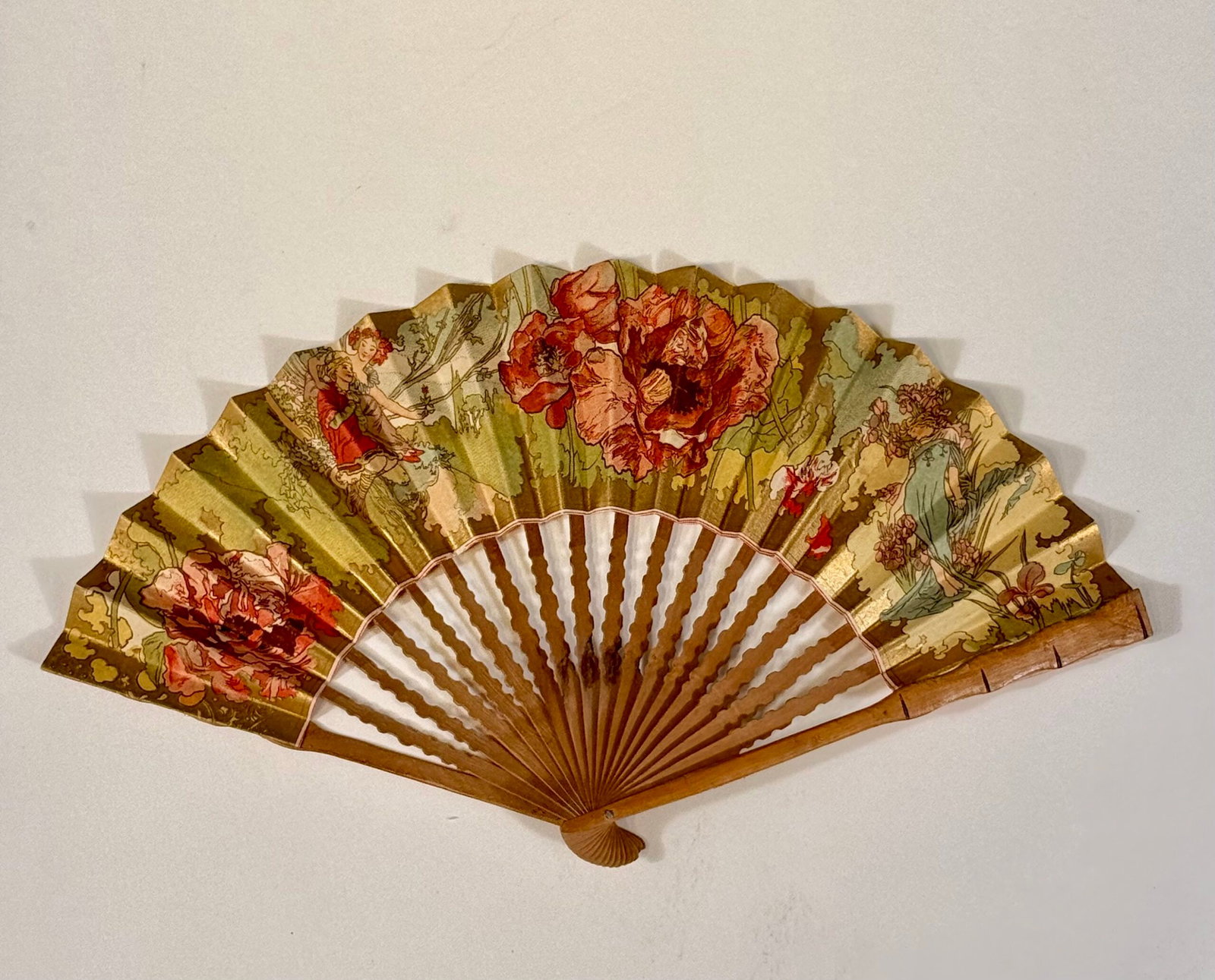 Alphonse Mucha : Fan, C. 1900: Alphonse Mucha (1860-1939) Fan, C. 1900 Folded fan of polylobed shape, the leaf in paper with a color lithograph heightened with gold metallic ink, depicting “Youth” from The Ages of Life and 