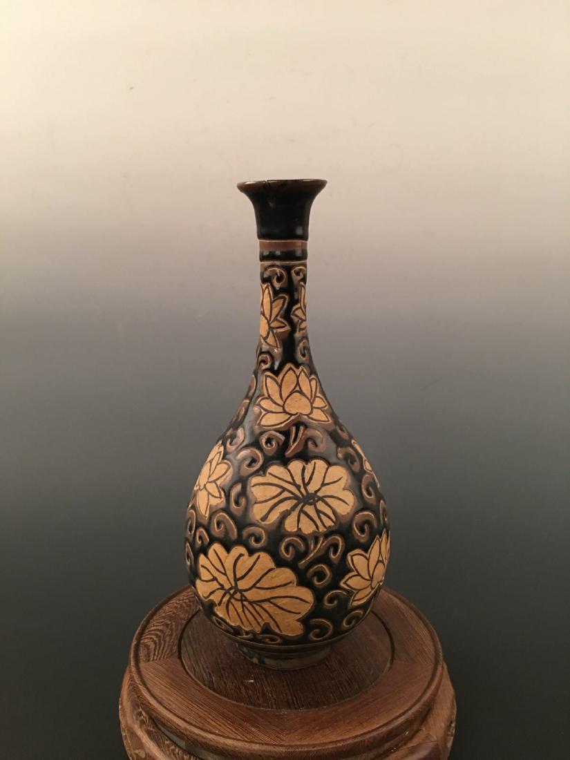 Chinese Ci Zhou Ware Porcelain Vase: Chinese Ci Zhou Ware Porcelain Vase 10-5/8'' H; 4-1/2'' W; 1.2 lb Shipping: We are able to pack and ship this item to an address in the United States for $35.00 via UPS Ground or USPS Priority Mail. T