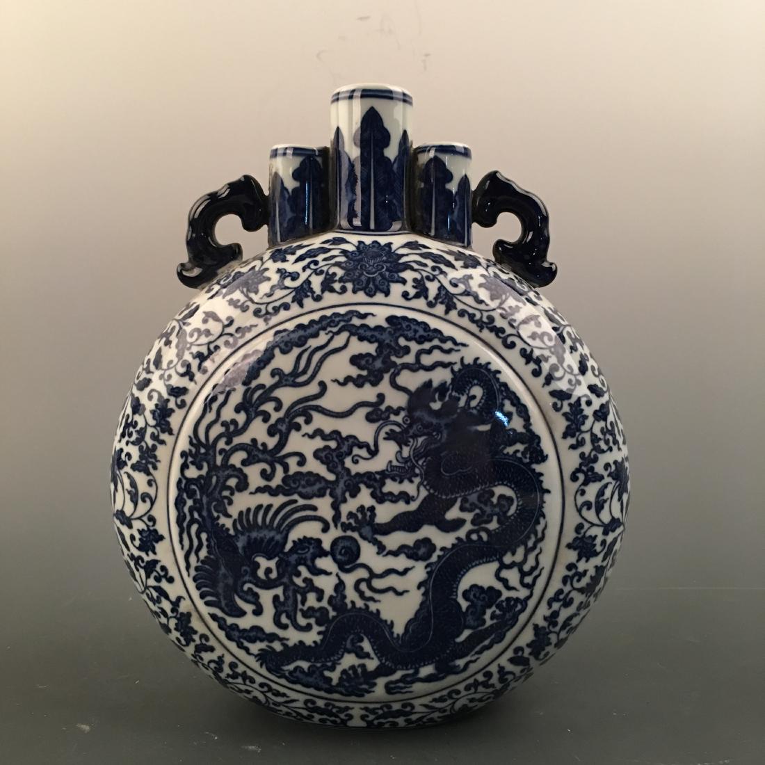Chinese Blue-White 'Dragon' Moon Flask Vase, Qianlong: Chinese Blue-White 'Dragon' Moon Flask Vase, Qianlong Mark 10'' H; 8-1/2'' W; 4.2 lb Shipping: We are able to pack and ship this item to an address in the United States via UPS Ground or USPS Priority