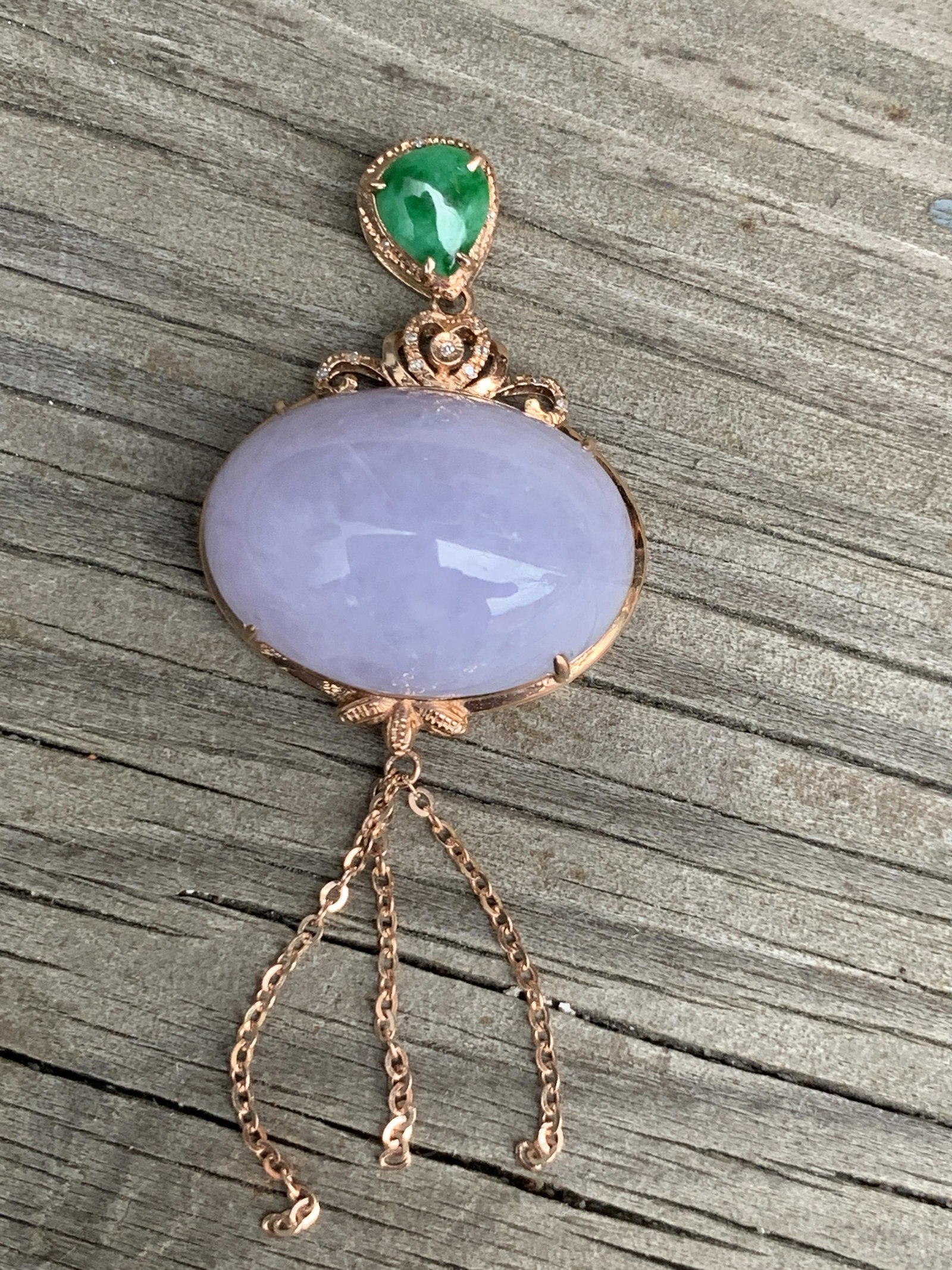 Mauve and Green Jadeite 18K Gold Pendant: Mauve and Green Jadeite 18K Gold Pendant 13 mm H, 19 mm W; 6 g Shipping: We are able to pack and ship this item to an address in the United States via UPS Ground or USPS Priority Mail for $20.00. Trac