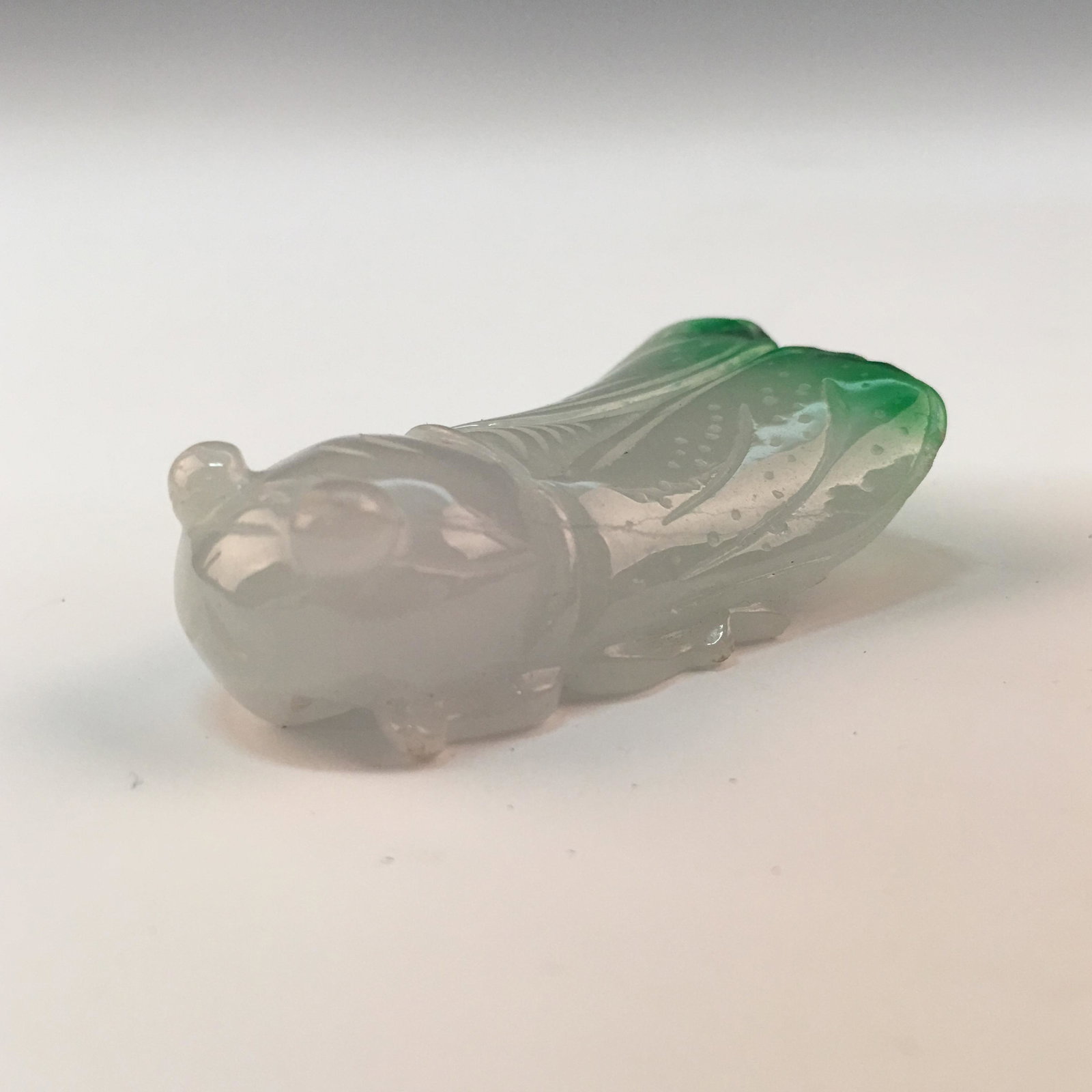 Chinese Emerald Cicade Pendant: Chinese Emerald Cicade Pendant 1-5/8'' H, 1'' W; 26 g Shipping: We are able to pack and ship this item to an address in the United States for $20.00 via UPS Ground or USPS Priority Mail. Tracking info