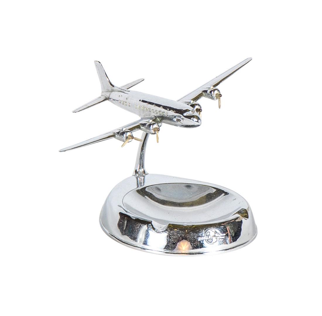 Metal Douglas Aircraft Promotional Executive Ashtray: A detailed promotional executive desk ashtray by Douglass Aircraft featuring a DC-6. The plane pivots on its ball-joint base. The original propellers are intact however, are missing a few blades. See