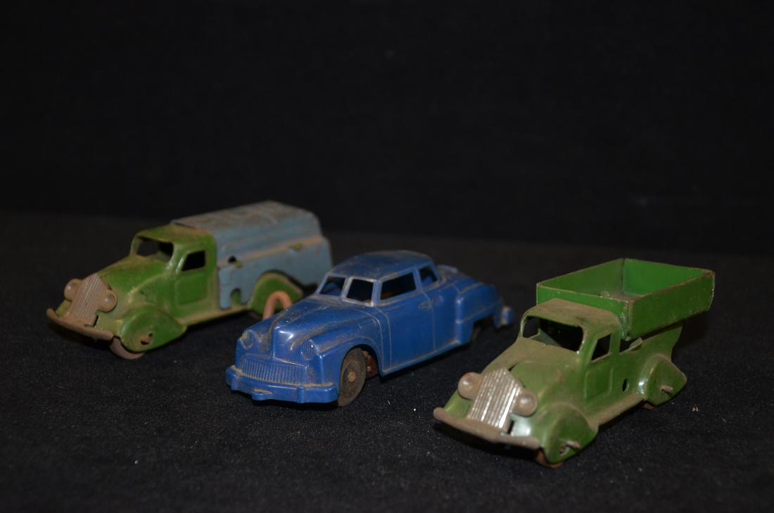 Vintage Tin car lot: Up for auction are two metal tin green trucks and one plastic wind up car. All for one money.