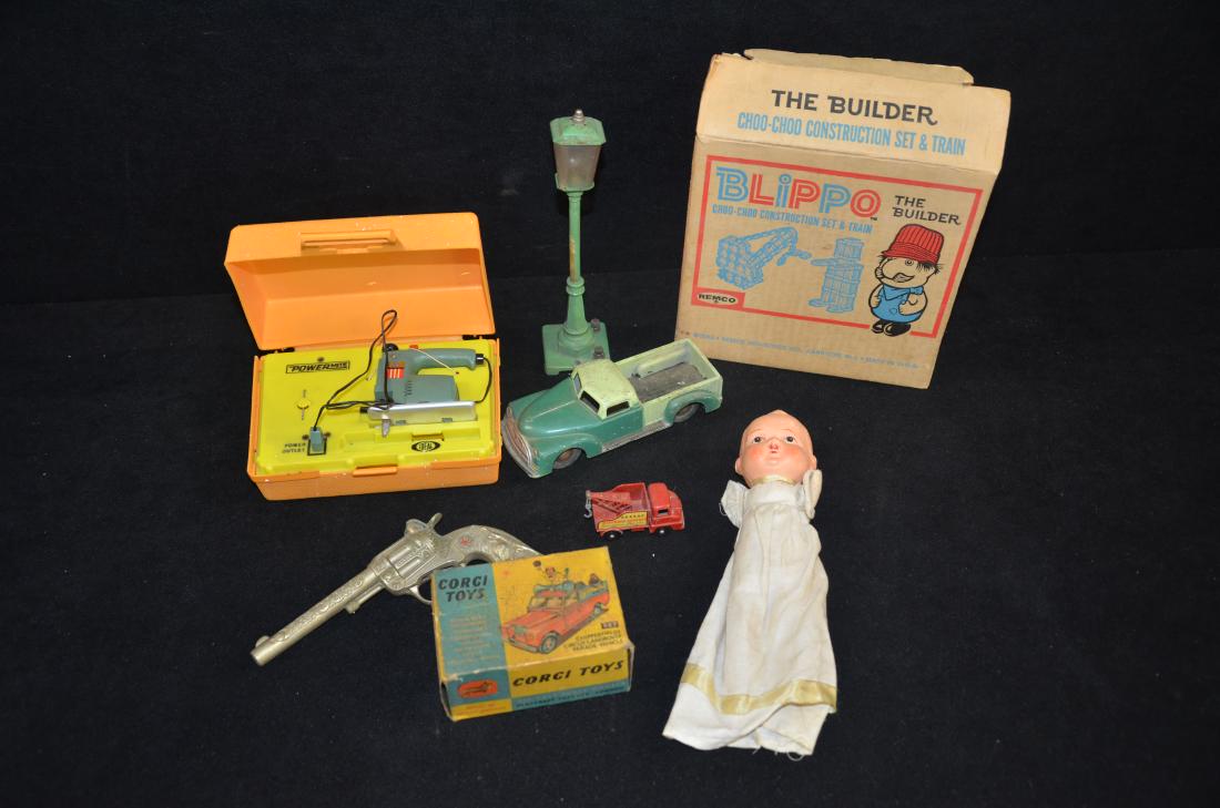 Vintage toy lot - tin car , pop gun: Up for auction is an assorted lot of vintage toys including a baby doll , empty corgi toy box , pop gun , tin toy in good condition , empty blimpo box , lionel lamp , and childrens play jig saw.