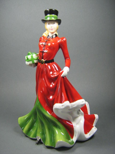 Royal Doulton Pretty Ladies Christmas Day HN4899: Royal Doulton Pretty Ladies "Christmas Day" HN4899 figurine. Copyright 2006. Good condition. Measures 7 1/2" high. Signed by Michael Doulton.